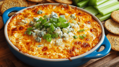 Create a vertical Pinterest Pin (2:3 ratio) for Fast Party Buffalo Chicken Dip. Style: fun, energetic party appetizer vibe. Show a hot, bubbling buffalo chicken dip in a colorful baking dish with melted cheese and buffalo sauce drizzle. Garnish with green onions. Surround with tortilla chips, celery sticks, and party napkins. Setting: game-day or party table. Lighting: bright, inviting, mouthwatering. Text overlay (bold, high-contrast font): “Fast Party Buffalo Chicken Dip” Subtext: Ready in Minutes • Crowd Favorite Clean layout, Pinterest-optimized, no clutter.